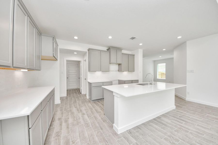 Step into a dream realized with this generously spacious kitchen! A massive granite island takes center stage, complemented by high ceilings and soft-close cabinets. The granite countertops, stainless steel appliances, sleek tile backsplash, and recessed lighting complete the elegant design. Step into a dream realized with this generously spacious kitchen! A massive granite island takes center stage, complemented by high ceilings and soft-close cabinets. The granite countertops, stainless steel appliances, sleek tile backsplash, and recessed lighting complete the elegant design.