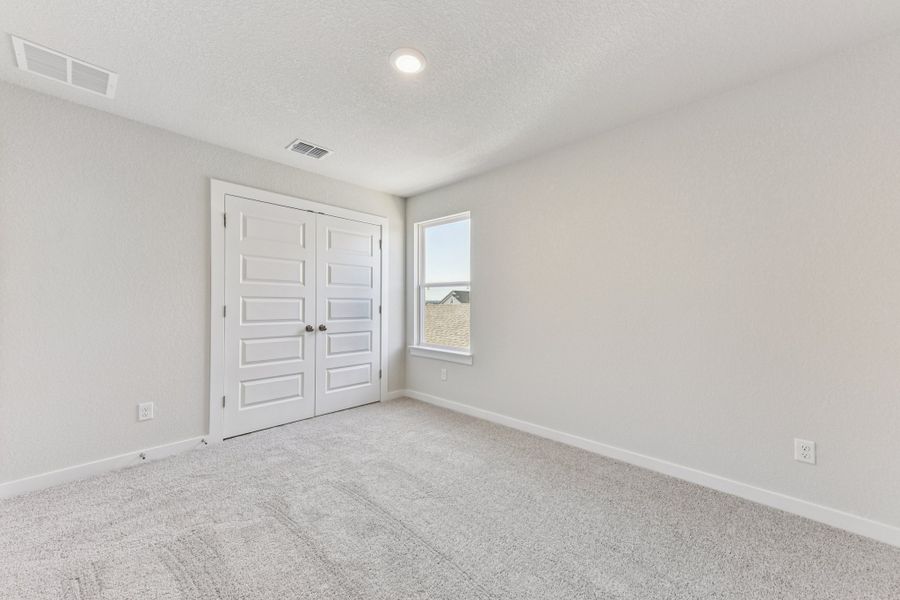 A room with white walls and a window.
