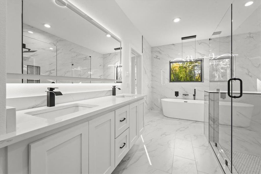 Bathroom featuring vanity, tile walls, and independent shower and bath