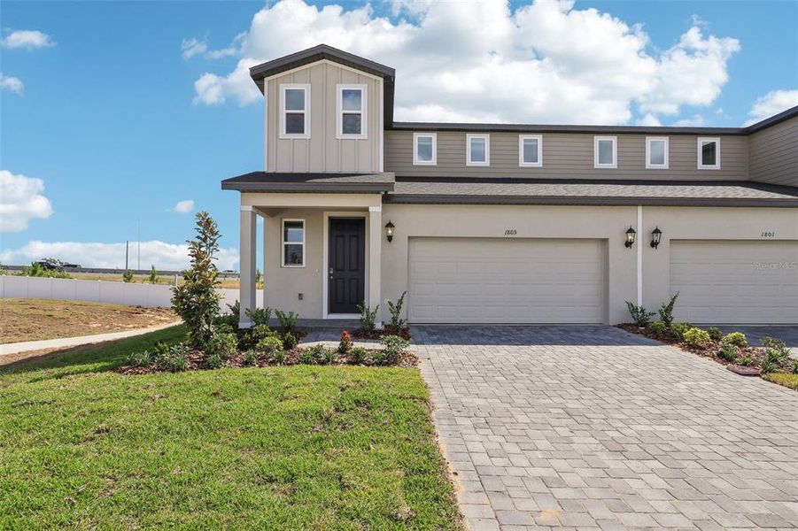 Front exterior of a new home in Cyrene at Minneola - Villas, Minneola, FL, highlighting curb appeal (Image 20).