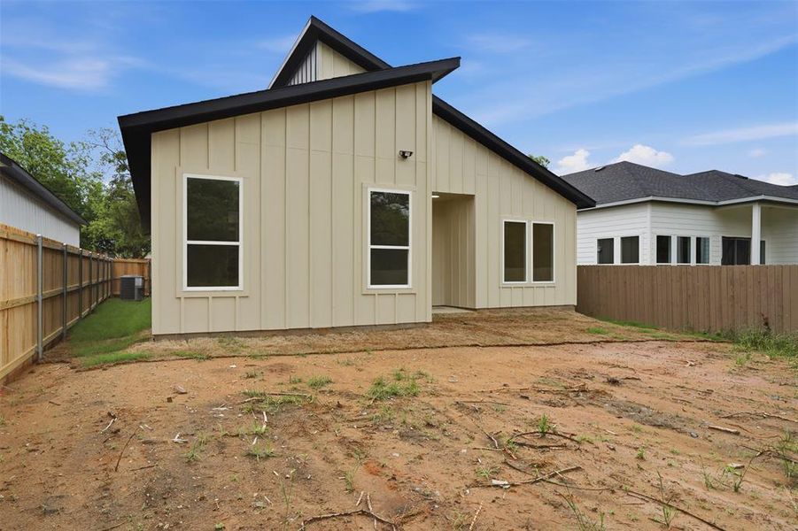 Contemporary-style residence with vertical siding and a dark-pitched roofline
