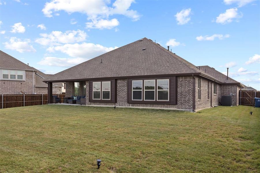 Back of property featuring a patio, a yard, and central air condition unit