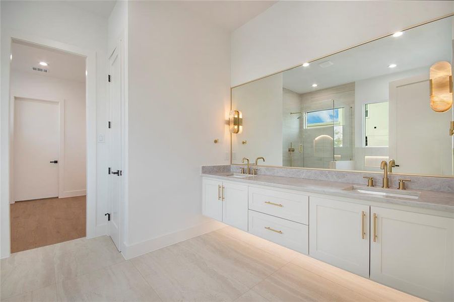 Bathroom with double vanity, recessed lighting, a stall shower, and light tile patterned flooring