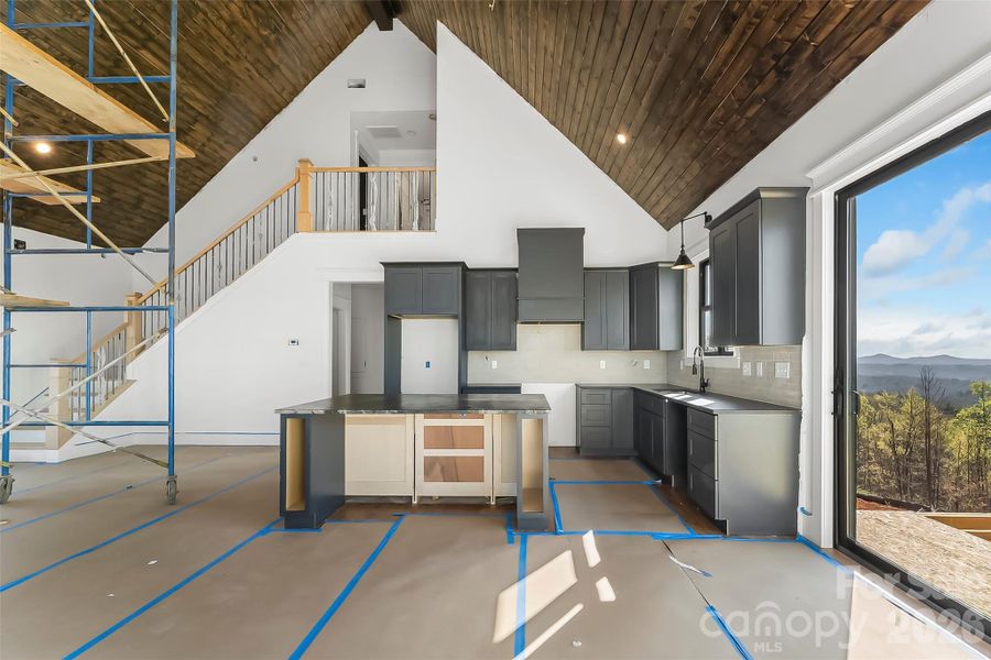 Beautiful kitchen with view of the stairs to the upper level Beautiful kitchen with view of the stairs to the upper level