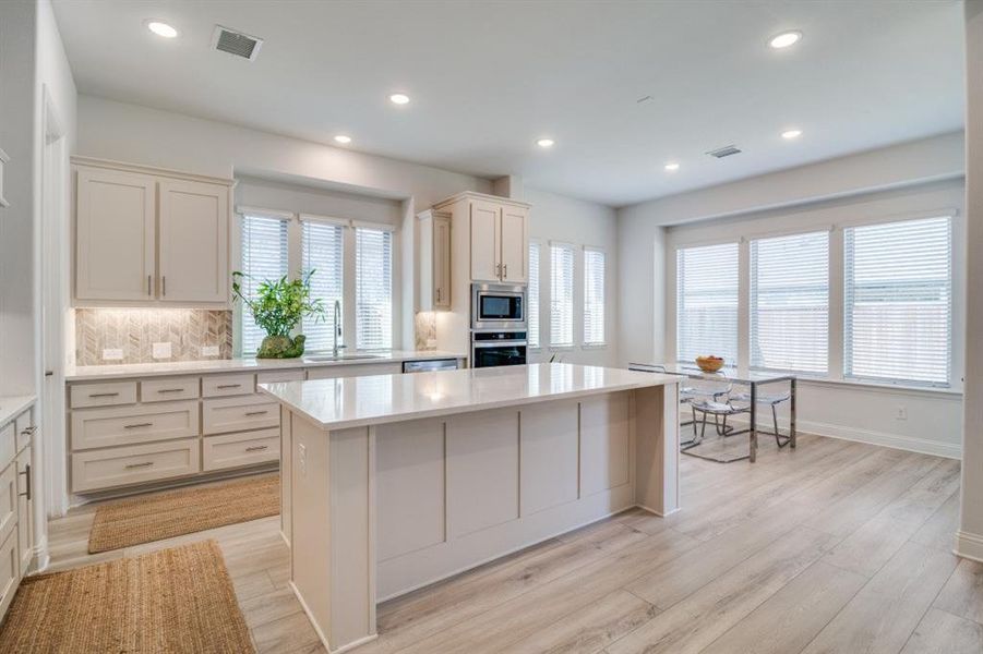 Kitchen featuring light countertops, visible vents, appliances with stainless steel finishes, and a sink Kitchen featuring light countertops, visible vents, appliances with stainless steel finishes, and a sink