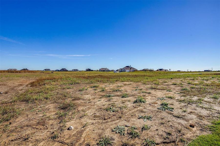 View of yard with a rural view