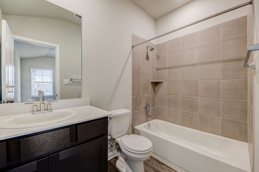 The secondary bathrooms in this home make getting ready easier for everyone.