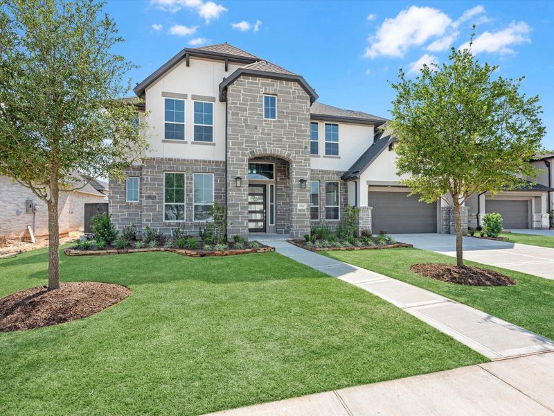 Front exterior of a new home in Harvest Green, Richmond, TX, highlighting curb appeal (Image 2). Front exterior of a new home in Harvest Green, Richmond, TX, highlighting curb appeal (Image 2).
