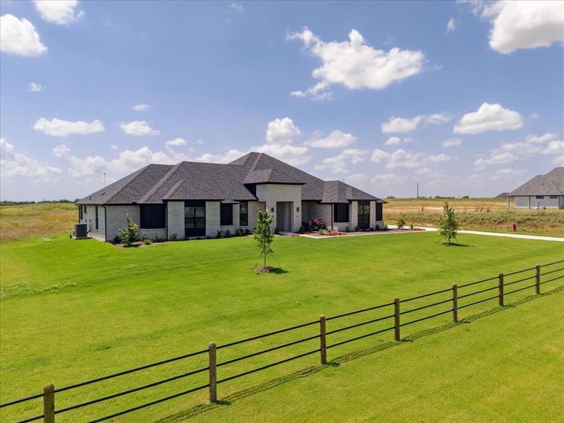 Front exterior of a new home in Coppenger Place, Godley, TX, highlighting curb appeal (Image 27). Front exterior of a new home in Coppenger Place, Godley, TX, highlighting curb appeal (Image 27).
