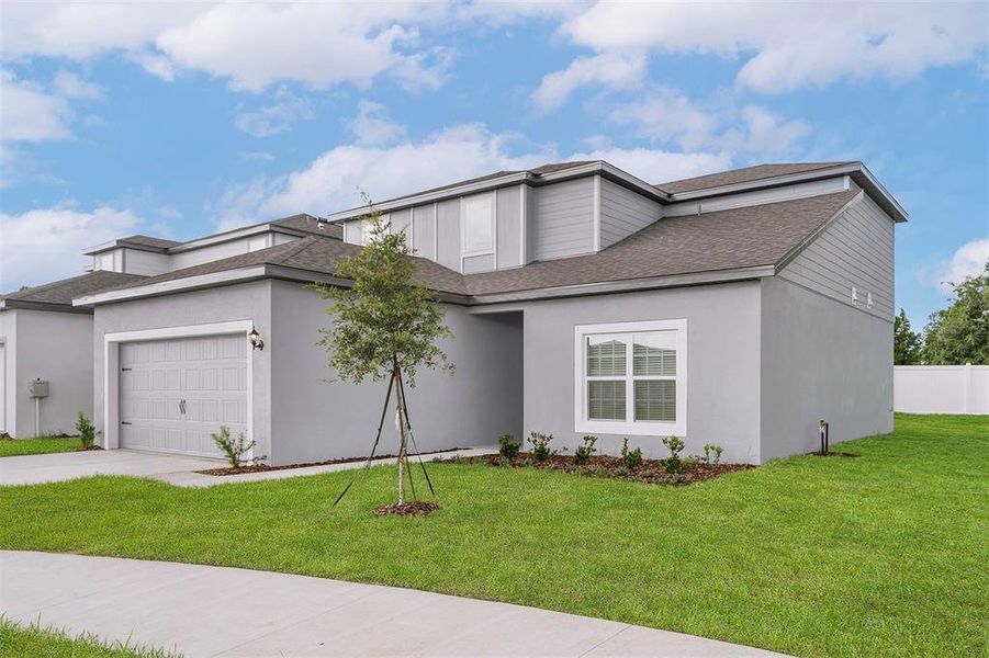 Front exterior of a new home in Tula Parc, Astatula, FL, highlighting curb appeal (Image 14).