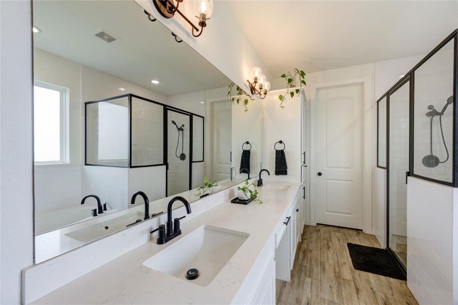 Dual vanities with quartz counters and stylish lighting
