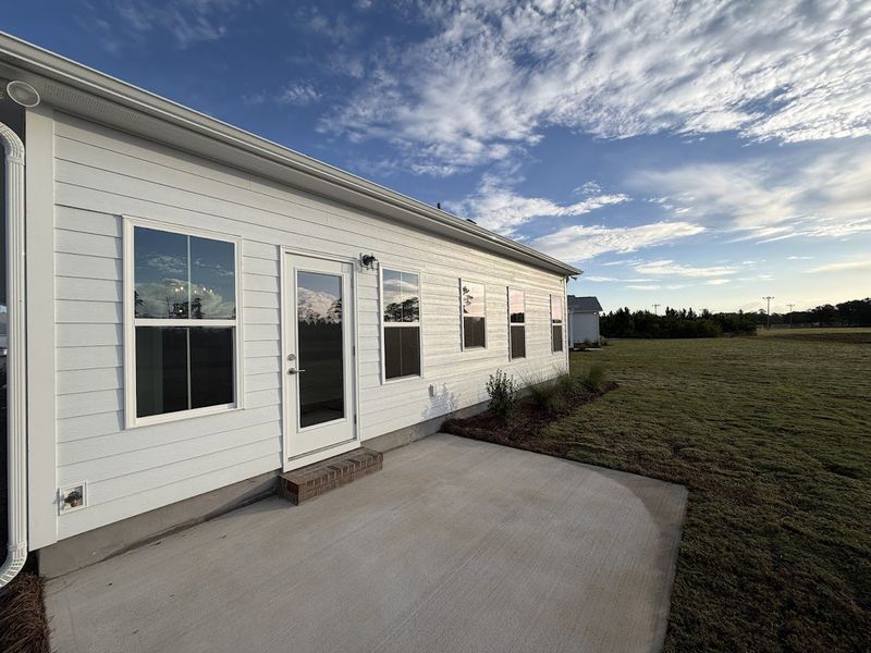 Exterior details and patio area of a home in Songbird, Hampstead (Image 19).