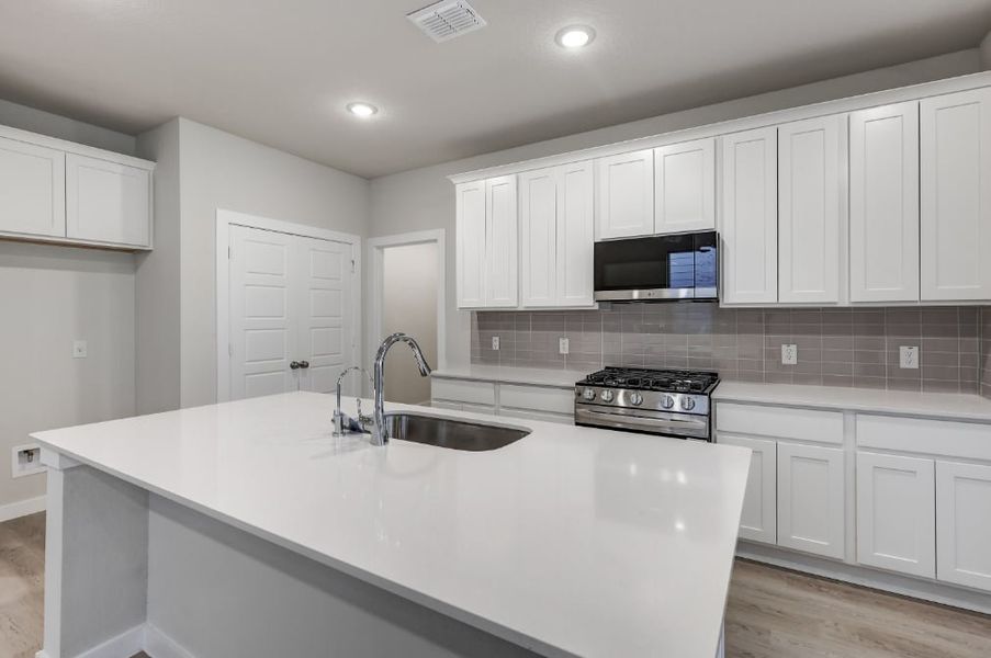 A kitchen with white cabinets. A kitchen with white cabinets.