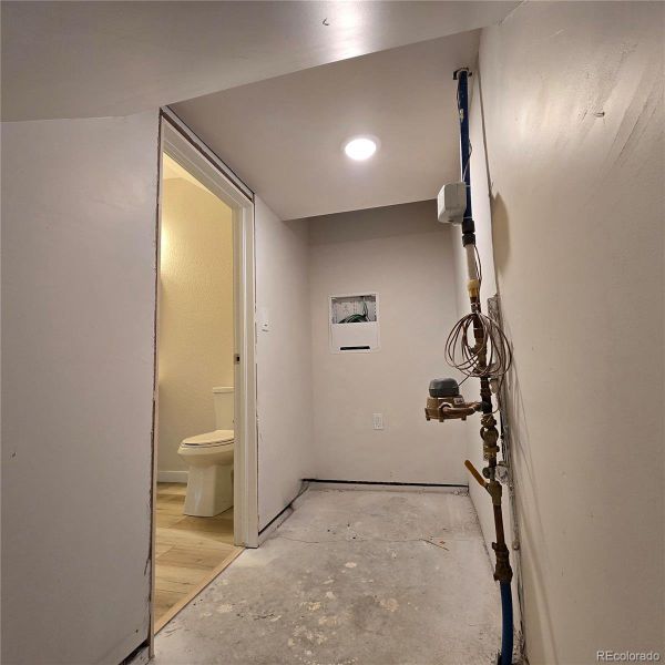 Under-stairs storage is accessed from the powder room.