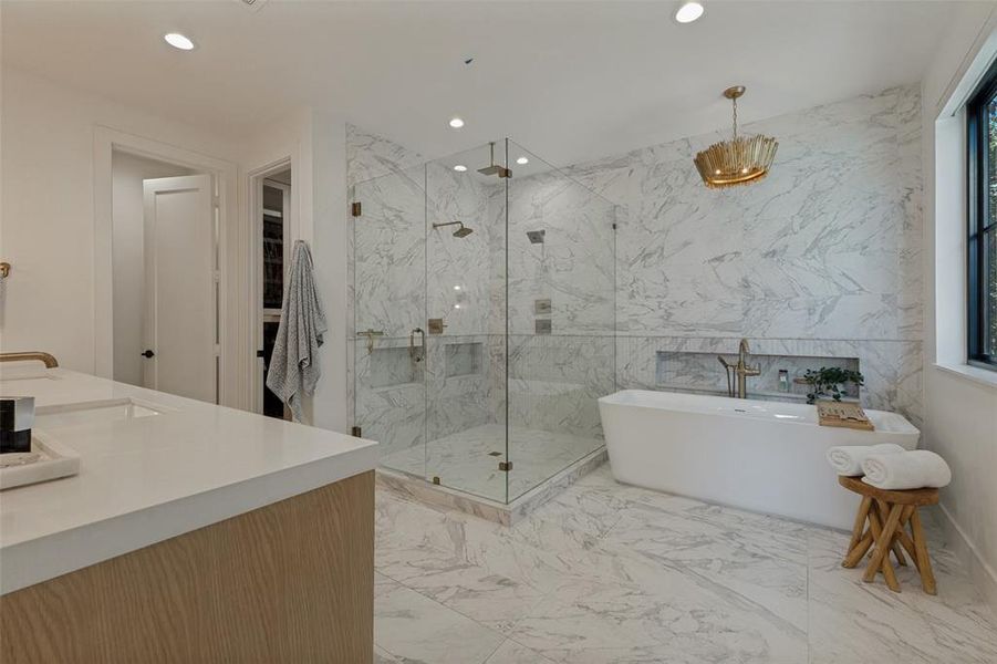 Spacious bathroom with white marble-patterned tile flooring and wall accents Spacious bathroom with white marble-patterned tile flooring and wall accents