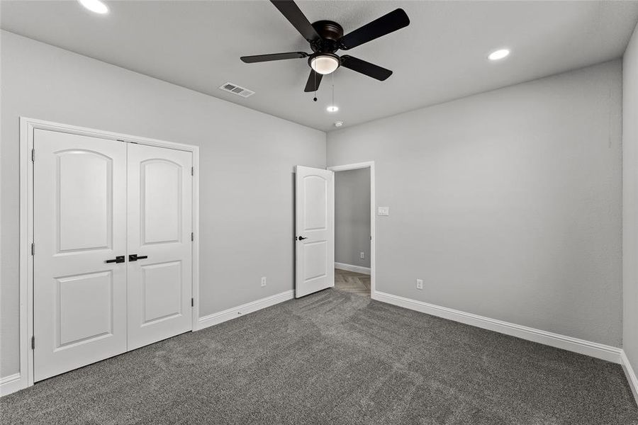 Unfurnished bedroom with dark carpet, recessed lighting, a closet, and ceiling fan Unfurnished bedroom with dark carpet, recessed lighting, a closet, and ceiling fan