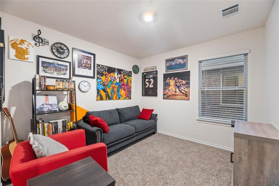 Living area with carpet floors and baseboards