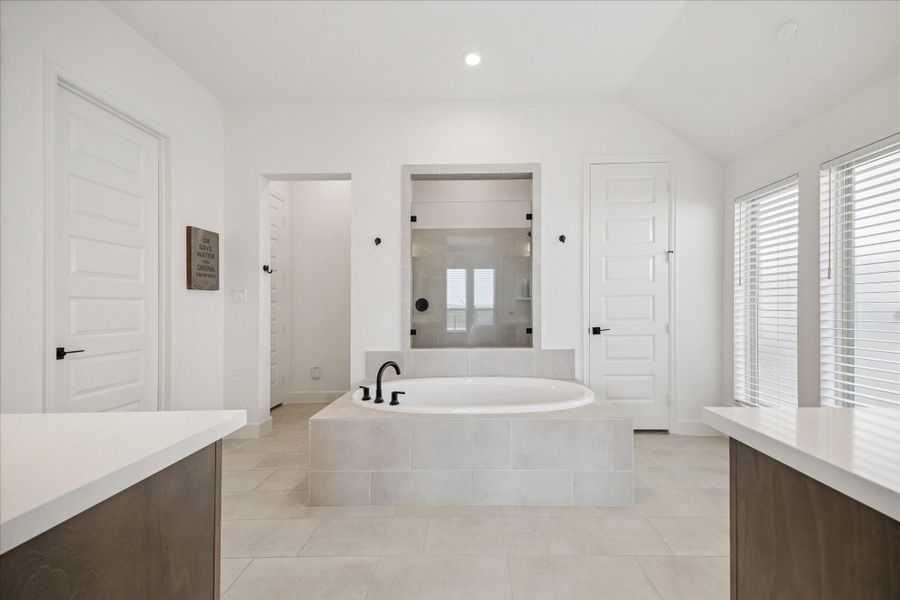 The primary bathroom has double closets and an oversized shower.