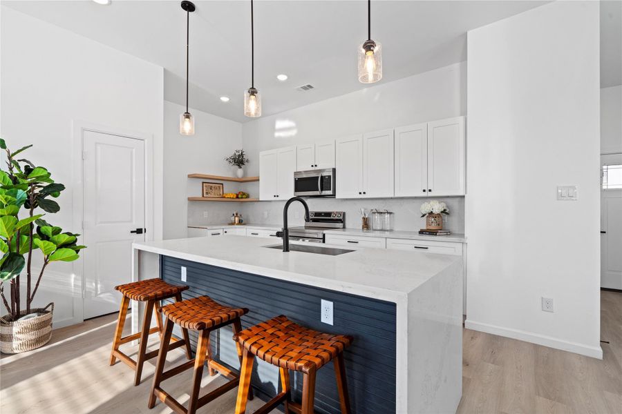 Quartz waterfall island does double duty—prep by day, casual bar by night—designer look without the premium markup. Quartz waterfall island does double duty—prep by day, casual bar by night—designer look without the premium markup.