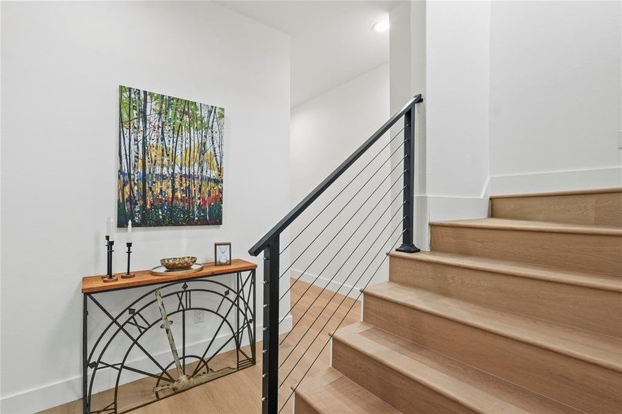 Stairway featuring wood finished floors and baseboards