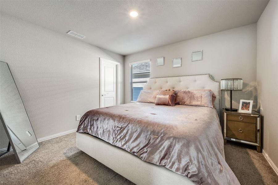 Bedroom featuring carpet floors and baseboards Bedroom featuring carpet floors and baseboards