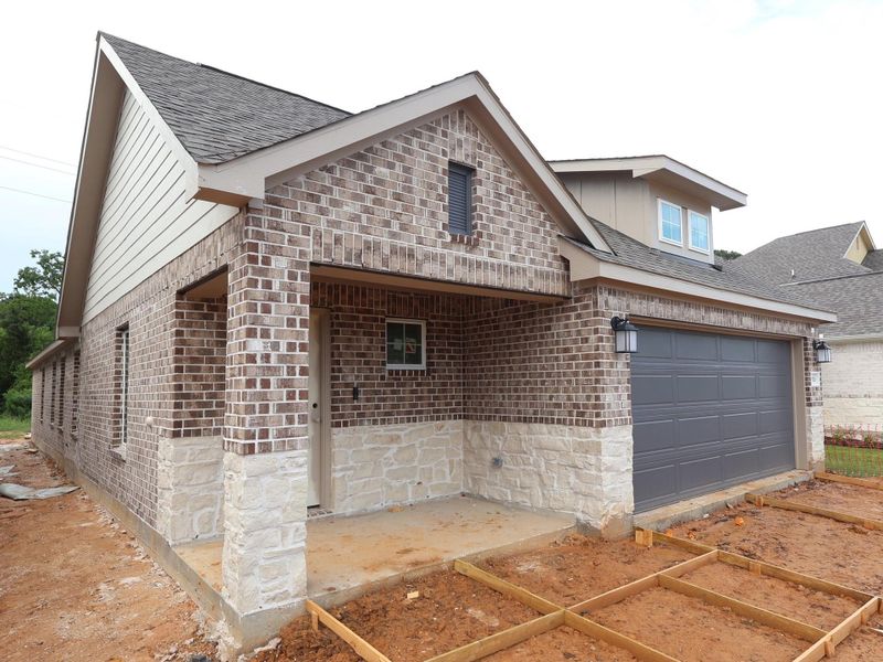 Front exterior of a new home in Sorella, Tomball, TX, highlighting curb appeal (Image 2). Front exterior of a new home in Sorella, Tomball, TX, highlighting curb appeal (Image 2).