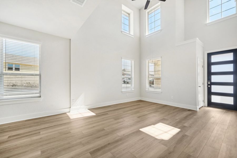 Living room and entry in the Medina floorplan at a Meritage Homes community.