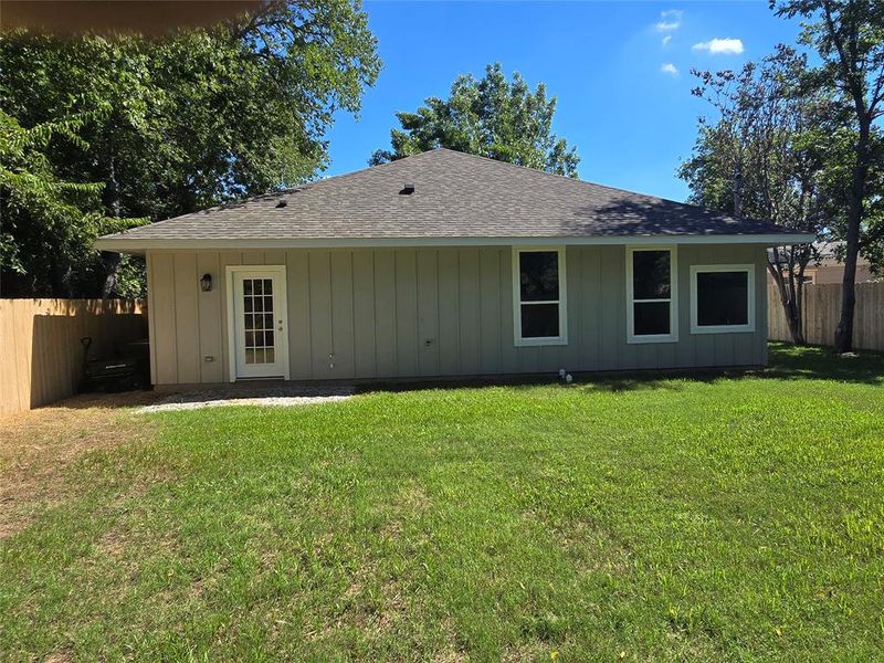 Rear view of house featuring a yard