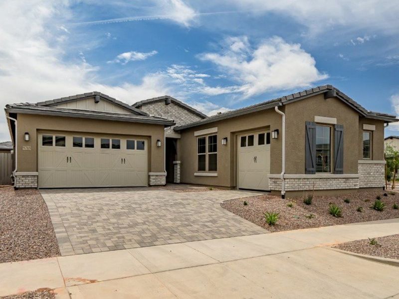 Front exterior of a new home in Elegance at Eastmark, Mesa, AZ, highlighting curb appeal (Image 1).