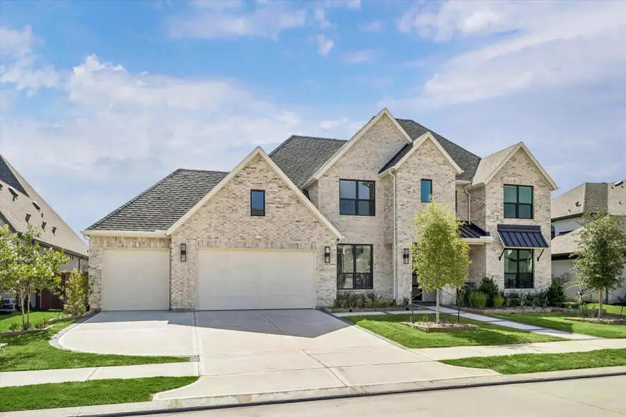 IMPRESSIVE TWO-STORY BRICK EXTERIOR WITH A THREE-CAR GARAGE, MULTIPLE ROOFLINES, AND A WIDE DRIVEWAY. IMPRESSIVE TWO-STORY BRICK EXTERIOR WITH A THREE-CAR GARAGE, MULTIPLE ROOFLINES, AND A WIDE DRIVEWAY.