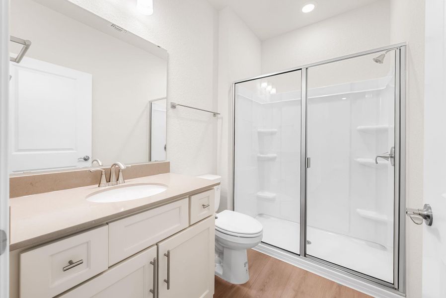 A well-appointed bathroom features a spacious shower and ample vanity counter space. A well-appointed bathroom features a spacious shower and ample vanity counter space.
