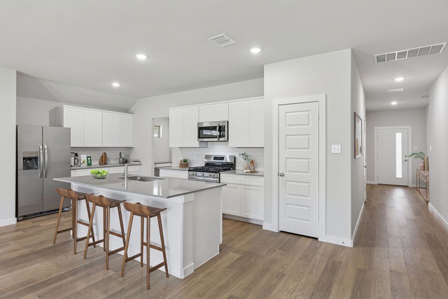 Kitchen in the Harrison home plan by Trophy Signature Homes – REPRESENTATIVE PHOTO