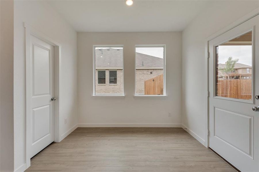 Empty room with light hardwood / wood-style floors