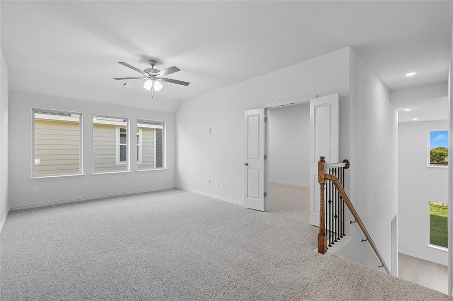 Carpeted spare room with a ceiling fan and recessed lighting Carpeted spare room with a ceiling fan and recessed lighting