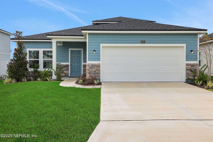 Front exterior of a new home in Cordova Palms, St. Augustine, FL, highlighting curb appeal (Image 21).