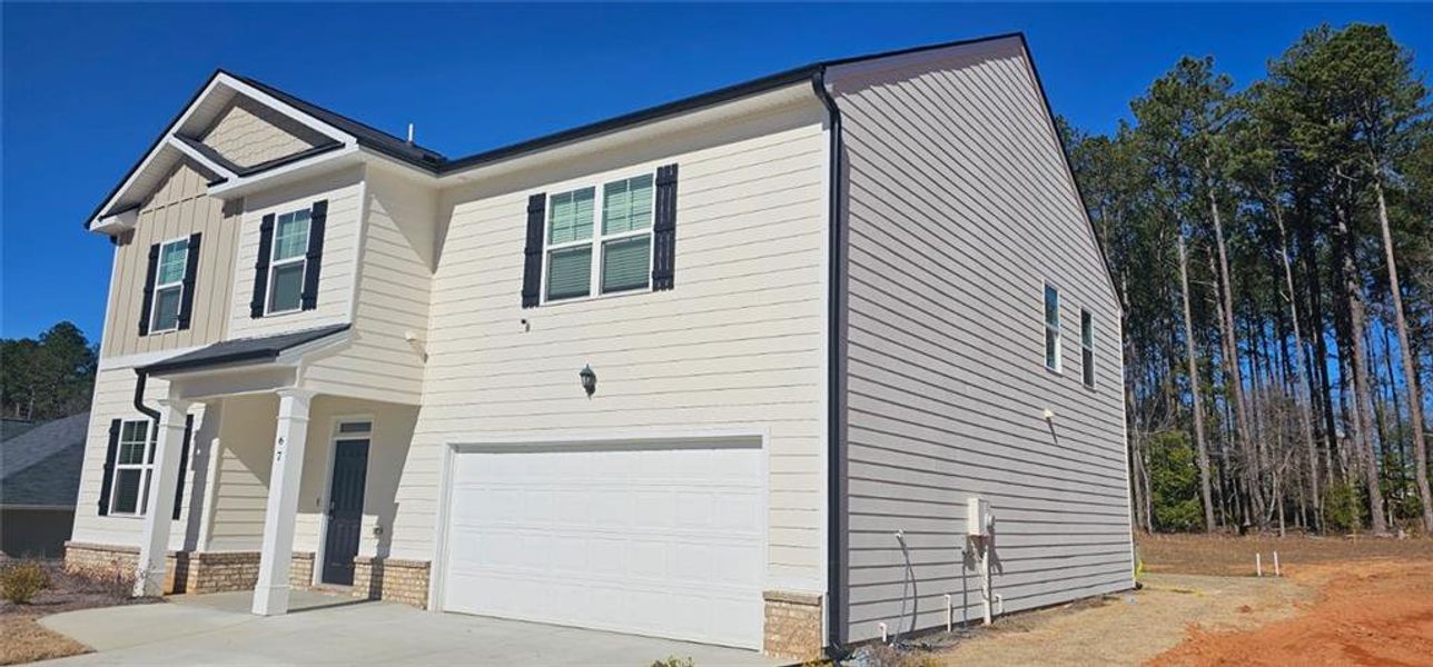 Front exterior of a new home in Stillwater Springs, Dacula, GA, highlighting curb appeal (Image 2).