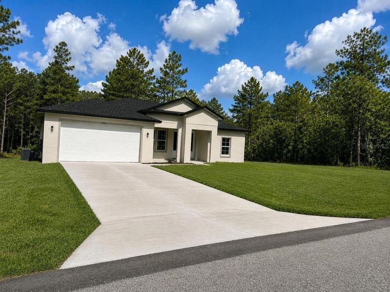 Front exterior of a new home in , Dunnellon, FL, highlighting curb appeal (Image 1). Front exterior of a new home in , Dunnellon, FL, highlighting curb appeal (Image 1).