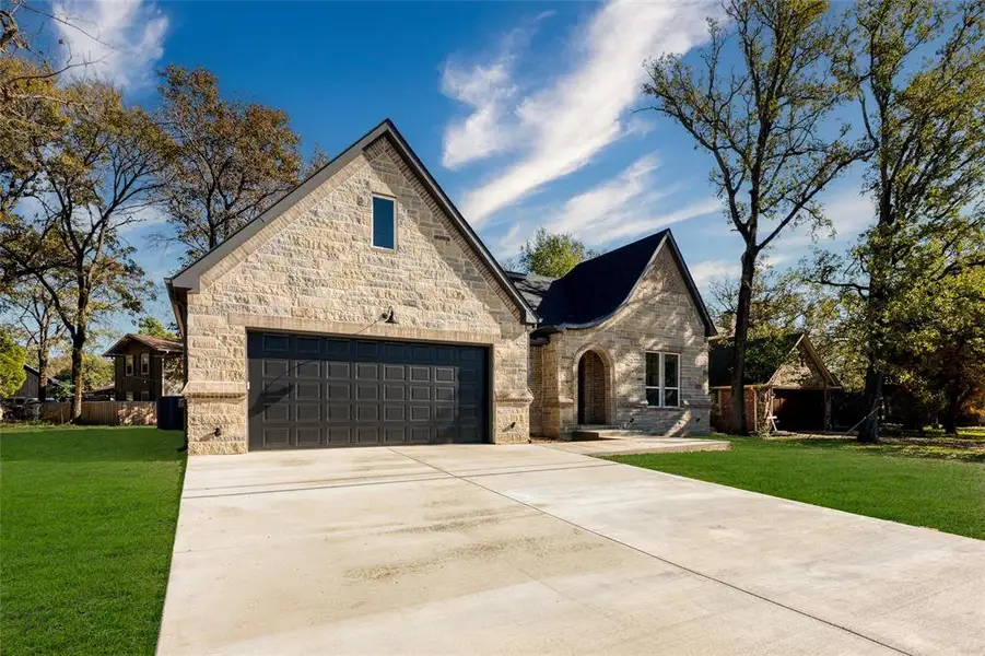 Front exterior of a new home in , Enchanted Oaks, TX, highlighting curb appeal (Image 2).