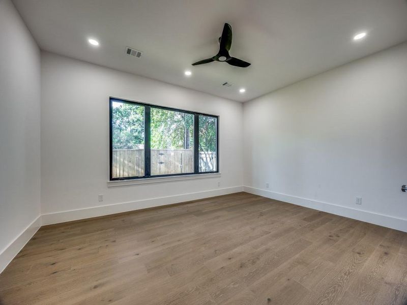 Unfurnished room with light wood-type flooring and ceiling fan