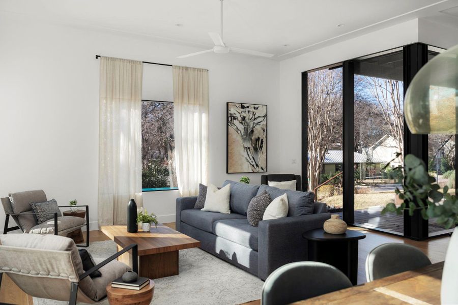 Living room with wood finished floors and ceiling fan