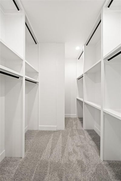 Walk in closet with light carpet