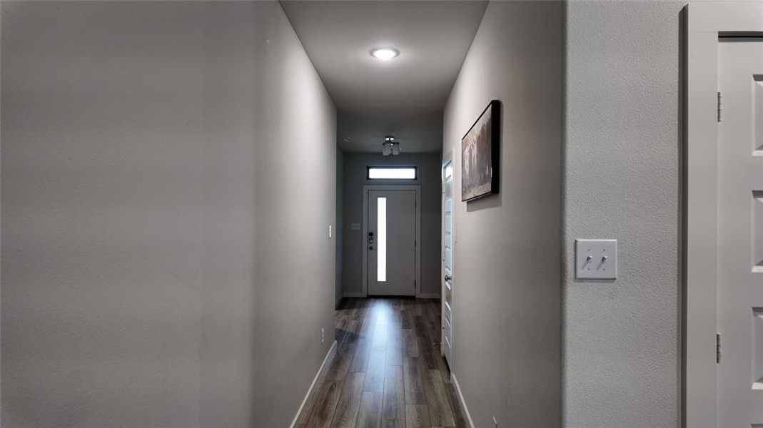 Inviting entryway with durable flooring, recessed lighting, and a transom window above the entry door