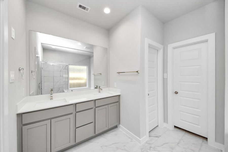 Elevate your daily routine at the elegant vanity, now equipped with double sinks, light countertops, modern hardware, and beautiful recessed lights. Sample photo of completed home with similar floor plan. Actual colors and selections may vary. Elevate your daily routine at the elegant vanity, now equipped with double sinks, light countertops, modern hardware, and beautiful recessed lights. Sample photo of completed home with similar floor plan. Actual colors and selections may vary.