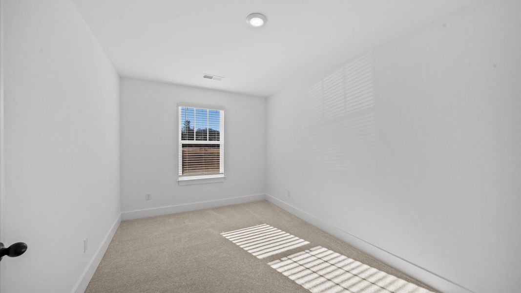 Vibrant and restful bedroom with oversized windows, refined detail, and a warm, welcoming atmosphere in Arden, NC