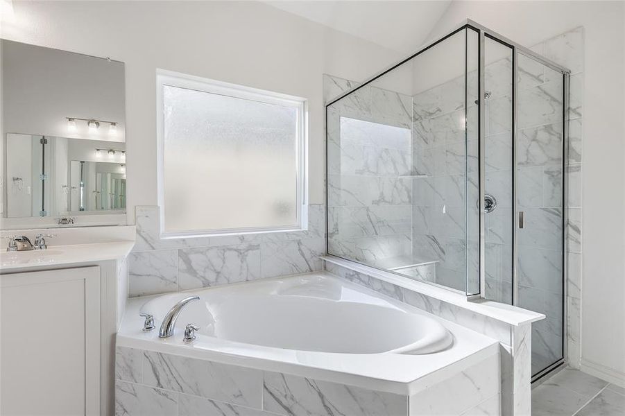 Full bath featuring a marble finish shower, a bath, and vanity Full bath featuring a marble finish shower, a bath, and vanity