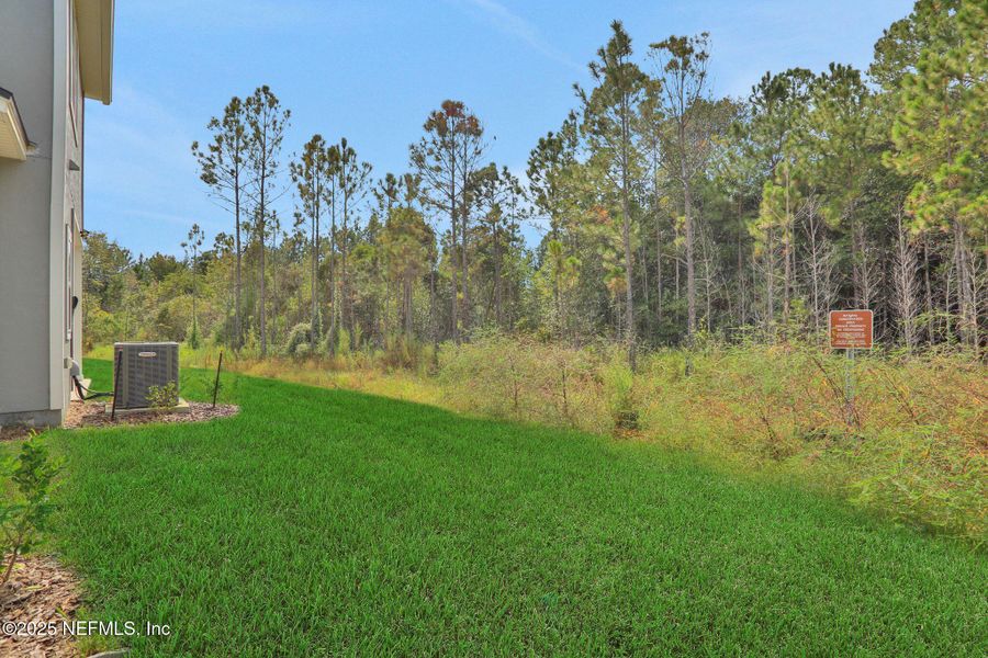 Front exterior of a new home in Atlantis Pointe, Middleburg, FL, highlighting curb appeal (Image 21).