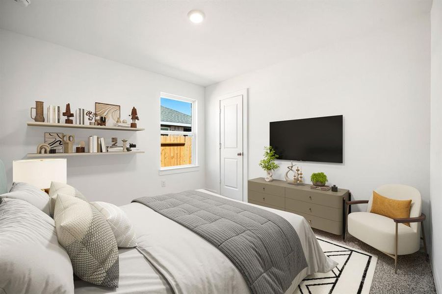 Secondary bedroom features plush carpet, lighting and a large window.