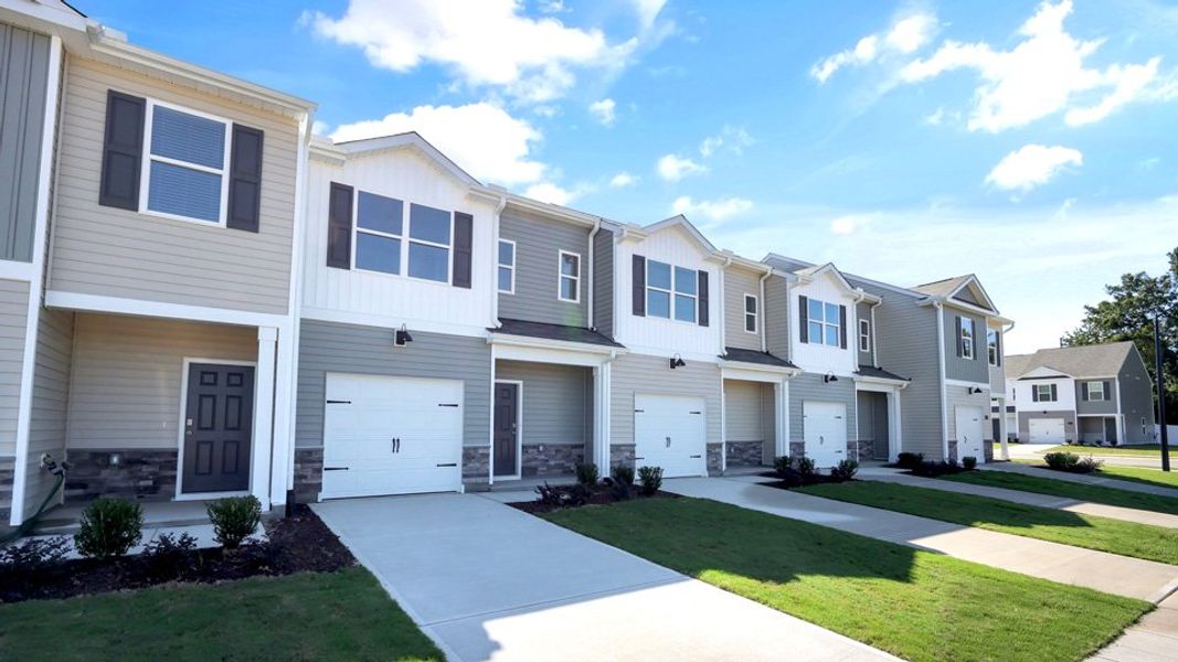 Front exterior of a new home in The Townes at Honeycutt Oaks, Angier, NC, highlighting curb appeal (Image 2). Front exterior of a new home in The Townes at Honeycutt Oaks, Angier, NC, highlighting curb appeal (Image 2).