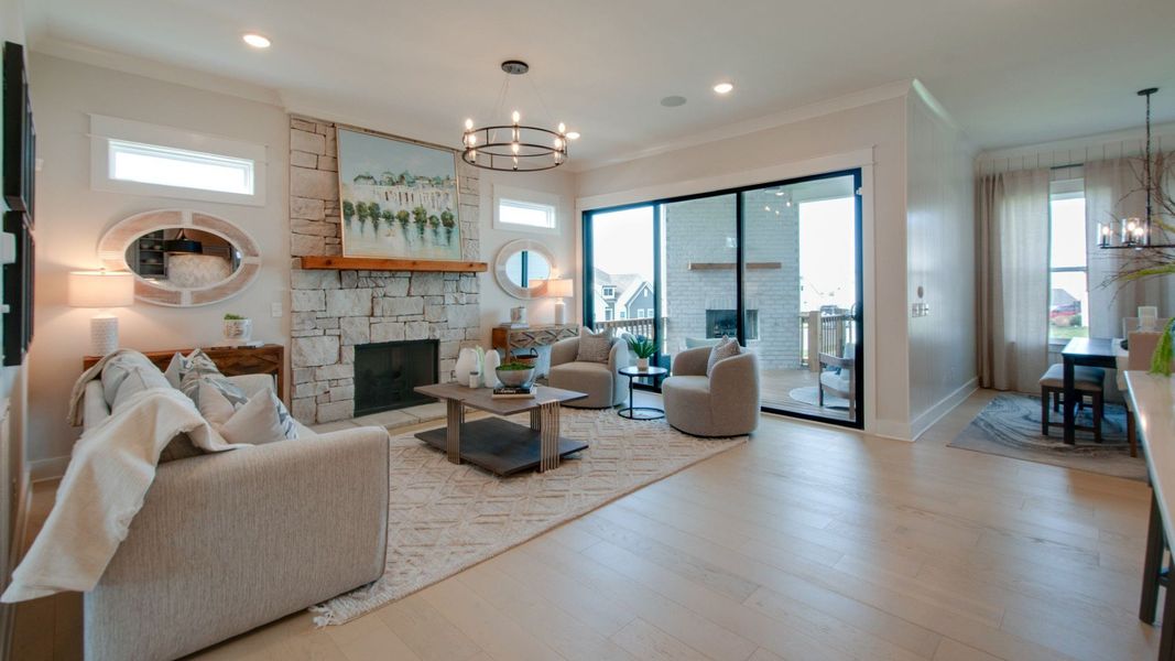 Gathering room with connecting dining area and large glass sliding doors out to the covered outdoor patio space Gathering room with connecting dining area and large glass sliding doors out to the covered outdoor patio space