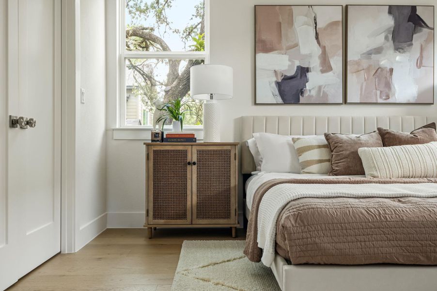 Well-lit sleeping quarters with rich hardwood floors and a vibrant outside view through the window. Well-lit sleeping quarters with rich hardwood floors and a vibrant outside view through the window.